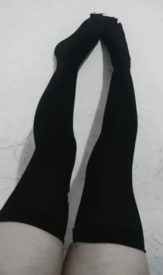 Person wearing black thigh-high stockings with exposed skin