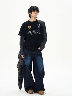 Person with black hair wearing a black long sleeve shirt and wide leg jeans
