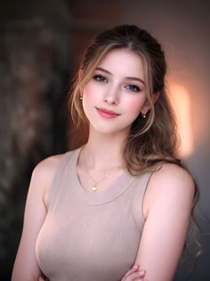 Woman with long hair in a ponytail wearing a sleeveless top and gold jewelry