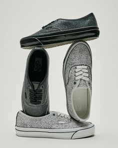 Three Vans shoes with a cracked texture, stacked on a white background