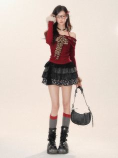 Woman in a red top with leopard print and a black mini skirt, holding a handbag