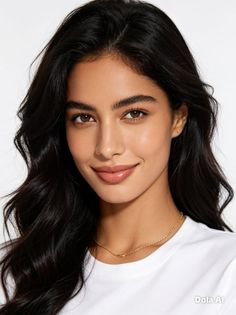 Woman with long black hair and a gold necklace wearing a white t-shirt