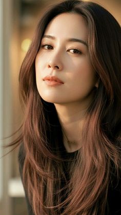 Woman with long brown hair in soft golden hour lighting