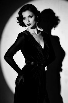 Woman in a velvet dress and long gloves with dramatic lighting and shadow