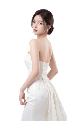 Woman in a white strapless wedding dress with an updo and pearl earrings