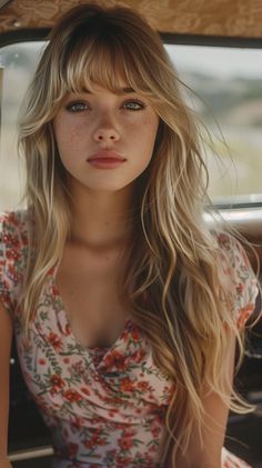 Woman with blonde hair and freckles wearing a floral dress