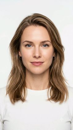 Woman with blue eyes and long blonde hair wearing a white shirt