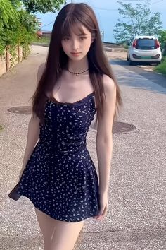 Woman with long hair wearing a floral dress and choker on a street