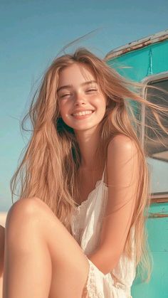 Smiling woman with long blonde hair and freckles in a white dress outdoors