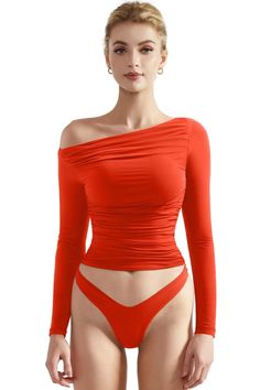 Woman in a red off-shoulder top and red underwear against a white background