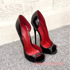 Pair of black patent leather high heels with red interior and peep toes