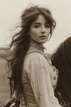 Woman with long, flowing hair in period clothing, looking over her shoulder
