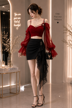 Woman in a red crop top and black mini skirt posing indoors
