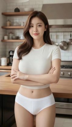 Woman in a white t-shirt and underwear in a kitchen