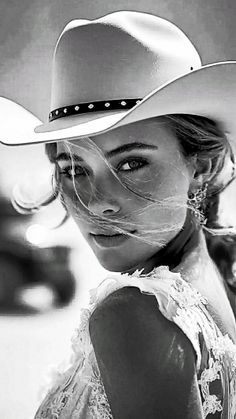 Woman in a cowboy hat with windblown hair in a black and white portrait