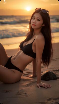 Woman in a black bikini posing on a beach at sunset