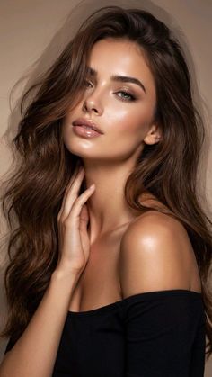 Woman with long brown hair and an off-shoulder top, touching her neck