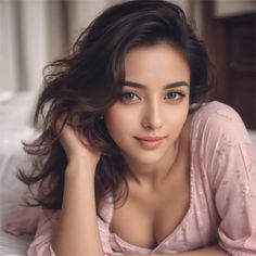 Woman with long dark hair in a pink top, lying down indoors