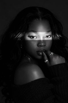 Woman with long hair in an off-shoulder sweater with dramatic lighting
