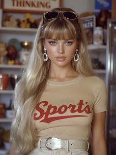 Woman with long blonde hair and bangs wearing a t-shirt and sunglasses on her head