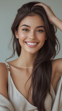 Smiling woman with long brown hair and natural makeup