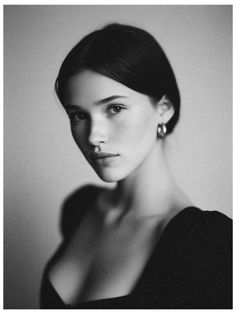 Black and white portrait of a woman with short dark hair and hoop earrings