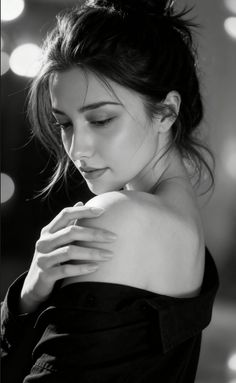 Woman with a messy bun and off-shoulder shirt in black and white