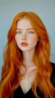 Woman with long red hair and blue eyes looking directly at the viewer