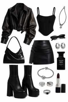 A collection of black clothing and accessories, including a leather jacket and platform boots