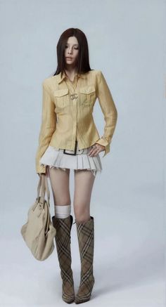 Person in a yellow shirt, mini skirt, and plaid boots holding a bag
