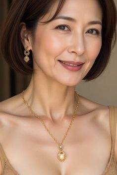 Woman with short hair and gold jewelry smiling at the camera