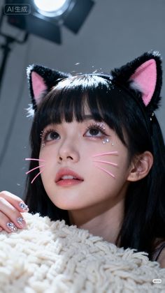 Woman with cat ears and rhinestone makeup looking up