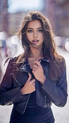 Woman with long hair wearing a leather jacket outdoors