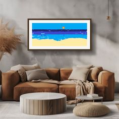 Living room with a brown sofa, coffee table, and abstract beach art on the wall