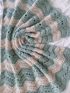 Crochet blanket with a chevron pattern in mint green and beige