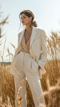 Woman in a linen suit standing in a wheat field under daylight