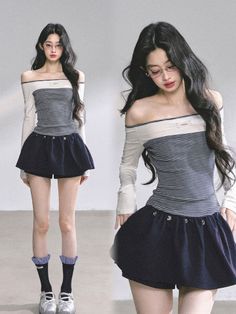 Woman with long dark hair wearing an off-shoulder top and mini skirt in a studio