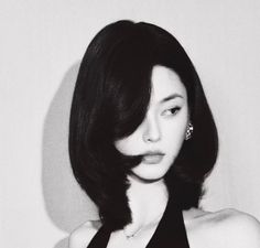 Woman with short black hair and a black dress in a black and white portrait