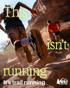 People trail running on a rocky path under bright sunlight