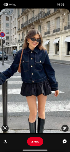 Woman in a denim jacket and mini skirt on a city street