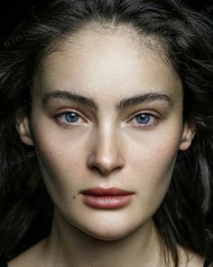 Close up portrait of a woman with blue eyes and dark hair
