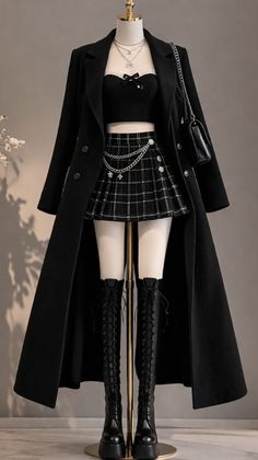 Mannequin displaying a dark aesthetic outfit with a long coat and plaid skirt