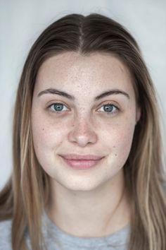 Woman with freckles and blue eyes looking directly at the camera