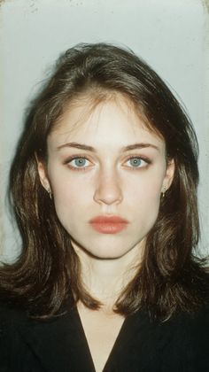 Woman with blue eyes and brown hair wearing earrings