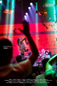 Woman dancing on stage in a sparkly top with confetti falling in a nightclub
