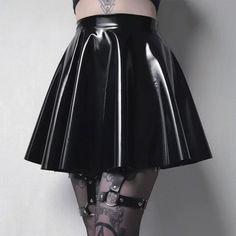Person wearing a black latex skirt, garter belt, and thigh high stockings