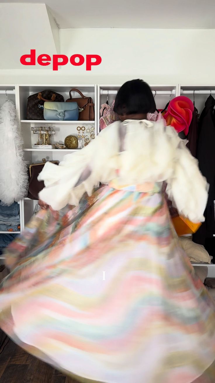 Person in a colorful dress with a ruffled top, captured with motion blur