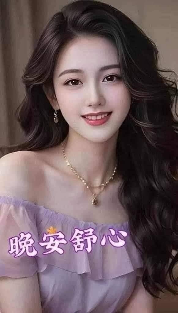 Smiling woman with long dark hair wearing an off-shoulder top and necklace