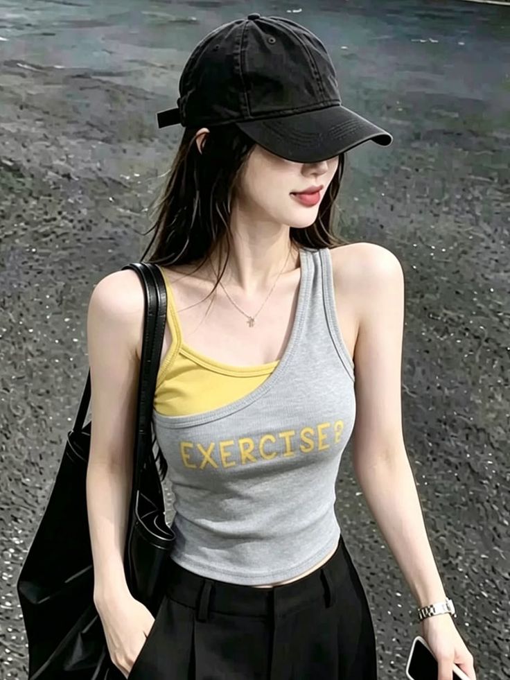 Woman in a black cap and tank top with long hair outdoors