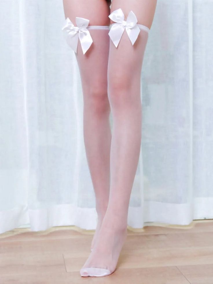 Person wearing white thigh-high stockings with bows